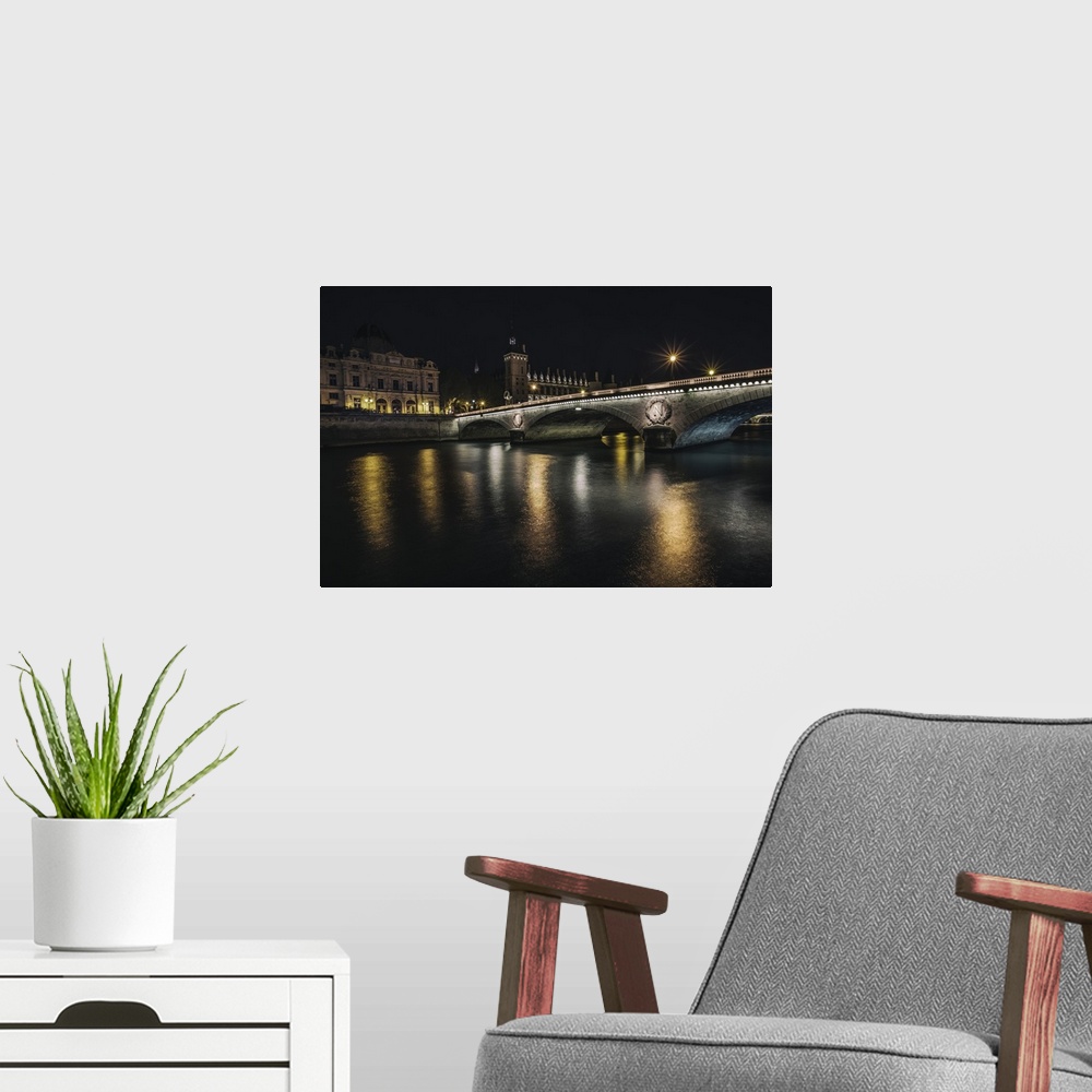A modern room featuring Bridge across the Seine at night in Paris, France