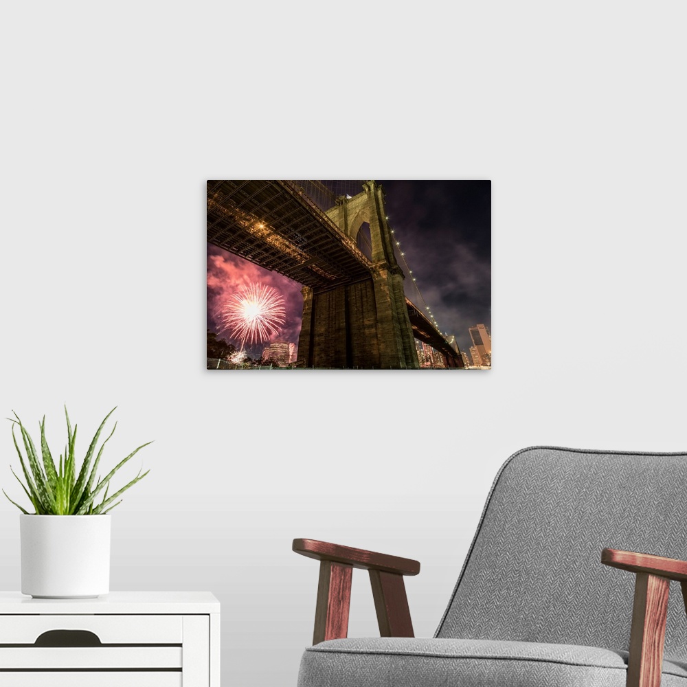 A modern room featuring Brooklyn Bridge and fireworks over Manhattan in NYC