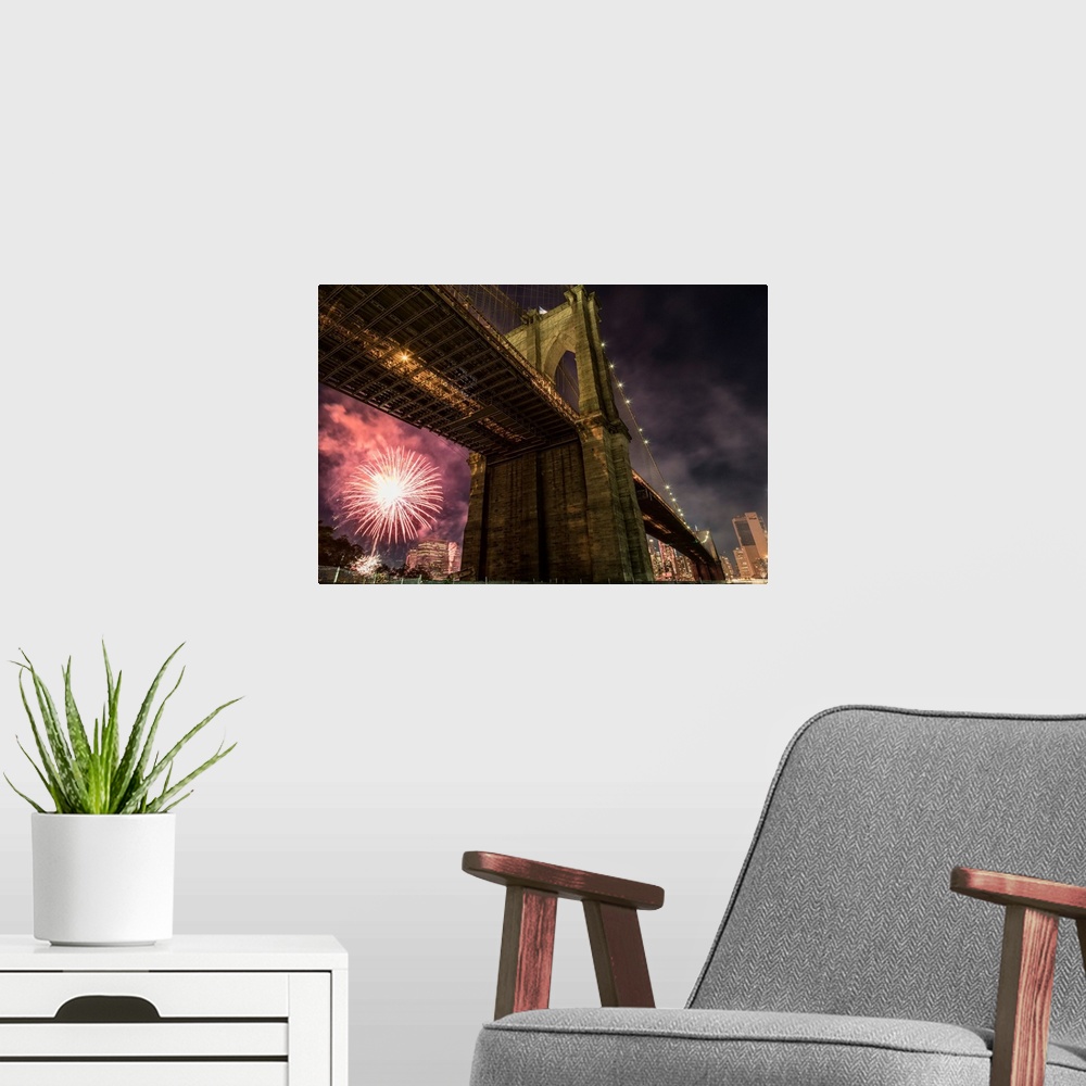 A modern room featuring Brooklyn Bridge and fireworks over Manhattan in NYC