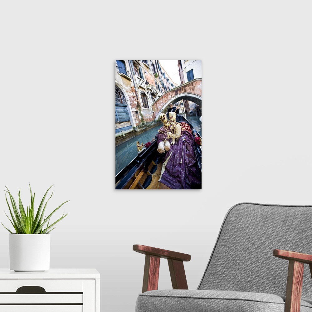 A modern room featuring Couple in Masquerade outfits kissing in Gondola underneath bridge, Venice, Italy