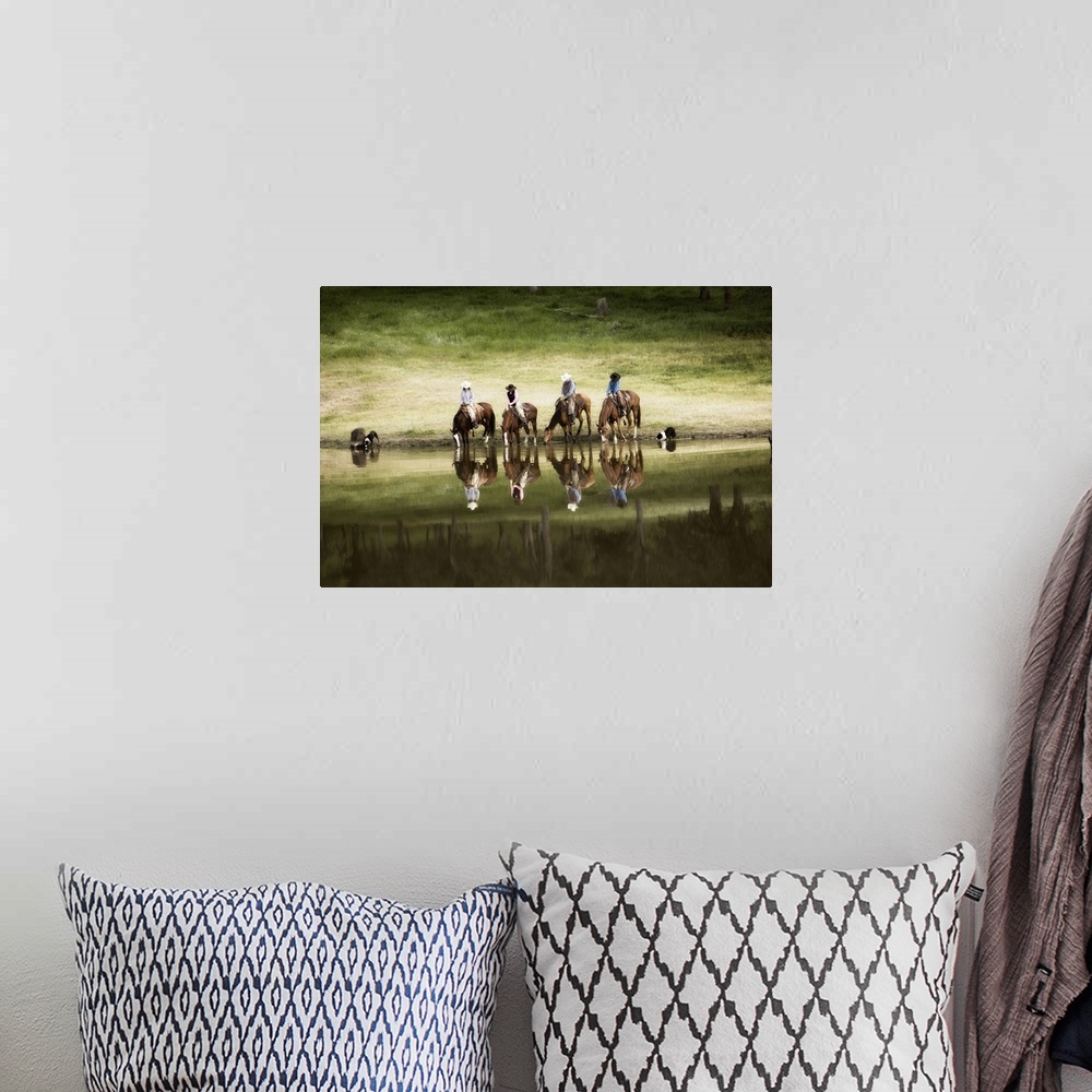 A bohemian room featuring Photograph of horseback riders and their dogs by water at dusk.  The riders and horses and reflec...
