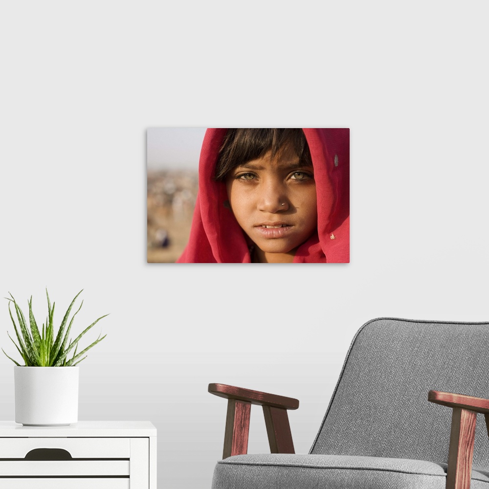 A modern room featuring Girl with red scarf at the Pushkar camel festival, Rajistan, India