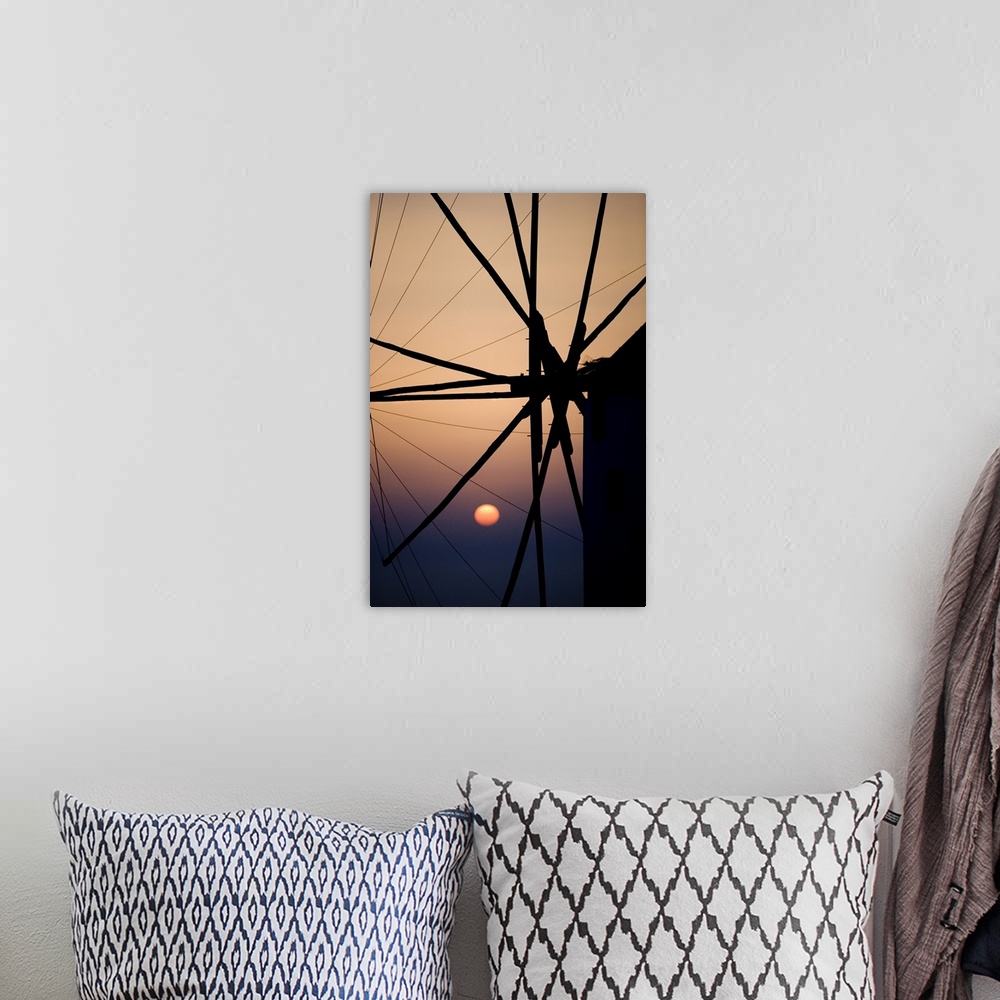 A bohemian room featuring Giant, vertical, close up photograph of the spokes of a windmill at sunset, in Mykonos, Greece.