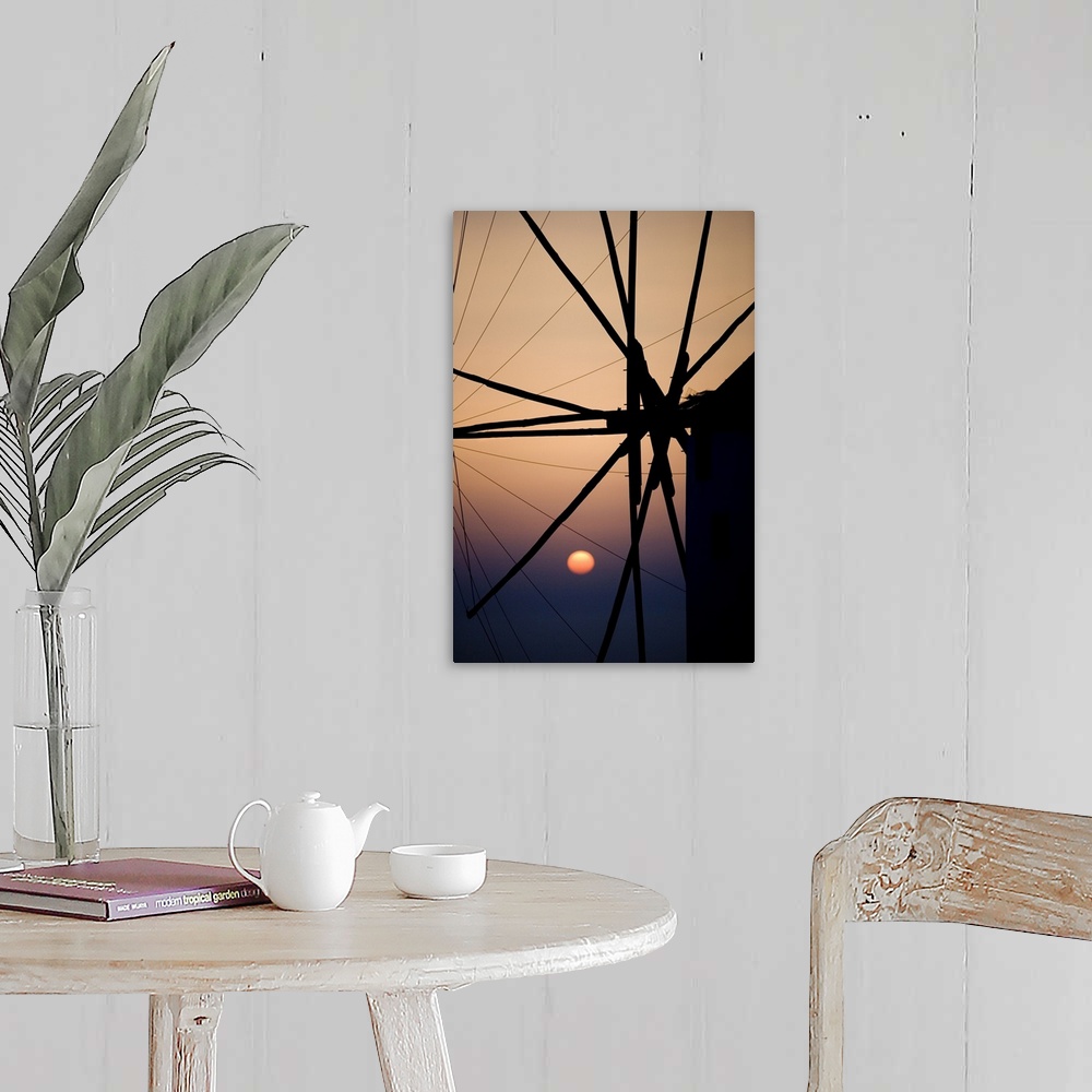 A farmhouse room featuring Giant, vertical, close up photograph of the spokes of a windmill at sunset, in Mykonos, Greece.