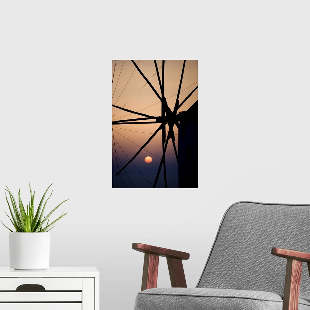 A modern room featuring Giant, vertical, close up photograph of the spokes of a windmill at sunset, in Mykonos, Greece.