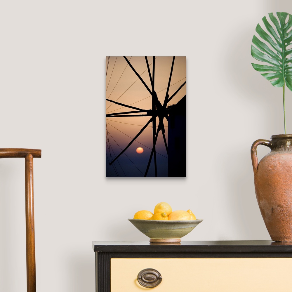 A traditional room featuring Giant, vertical, close up photograph of the spokes of a windmill at sunset, in Mykonos, Greece.