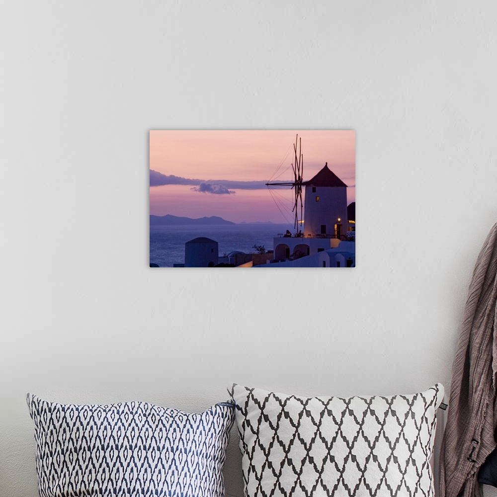 A bohemian room featuring Photograph of historic city lit up at dusk with  mountains in the distance under a cloudy sky.