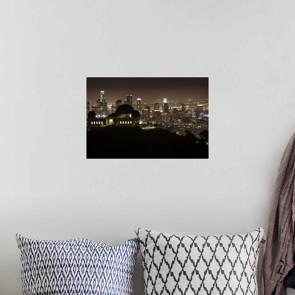 A bohemian room featuring Griffith Park Observatory and downtown LA at night