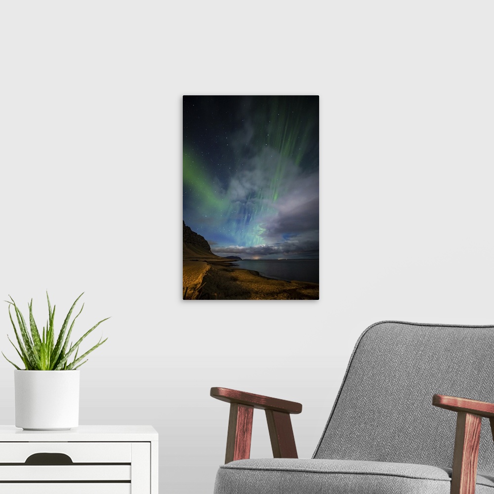 A modern room featuring Aurora borealis above the coast in Iceland.