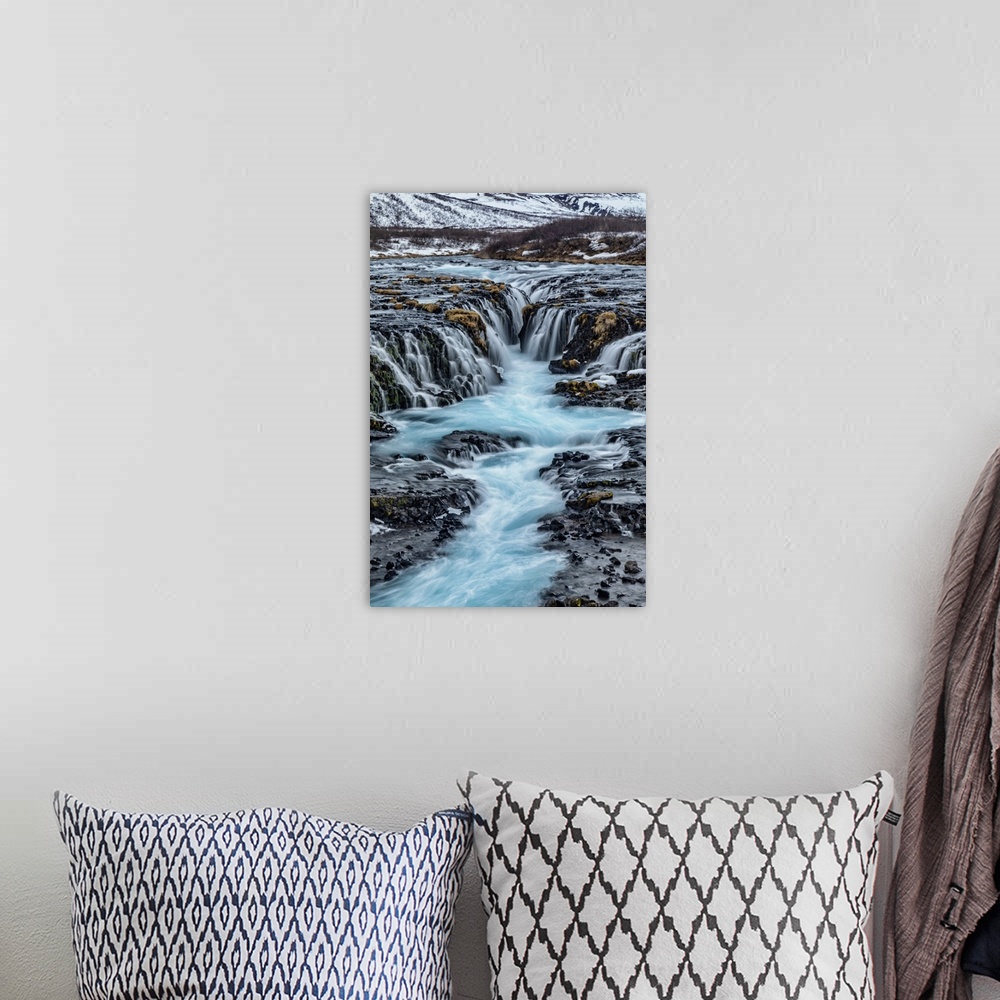 A bohemian room featuring Bruarfoss waterfall in winter in Iceland.