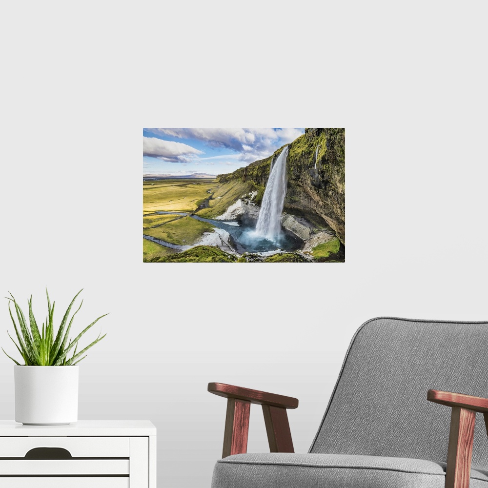A modern room featuring Seljalandsfoss waterfall in south Iceland.
