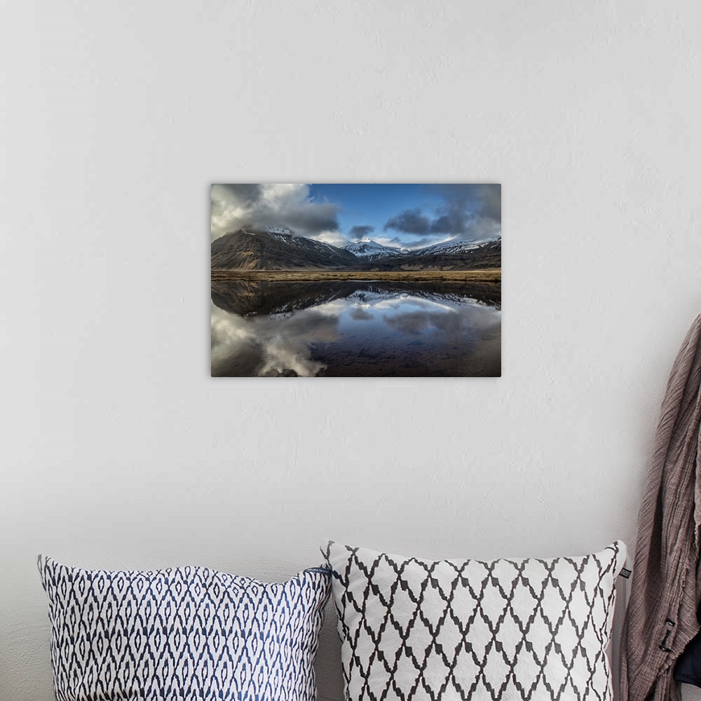 A bohemian room featuring Snow covered mountain reflecting in a lake in Iceland.