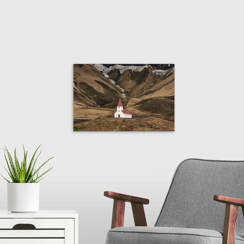 A modern room featuring The beautiful church on the hillside in Vik, Iceland.