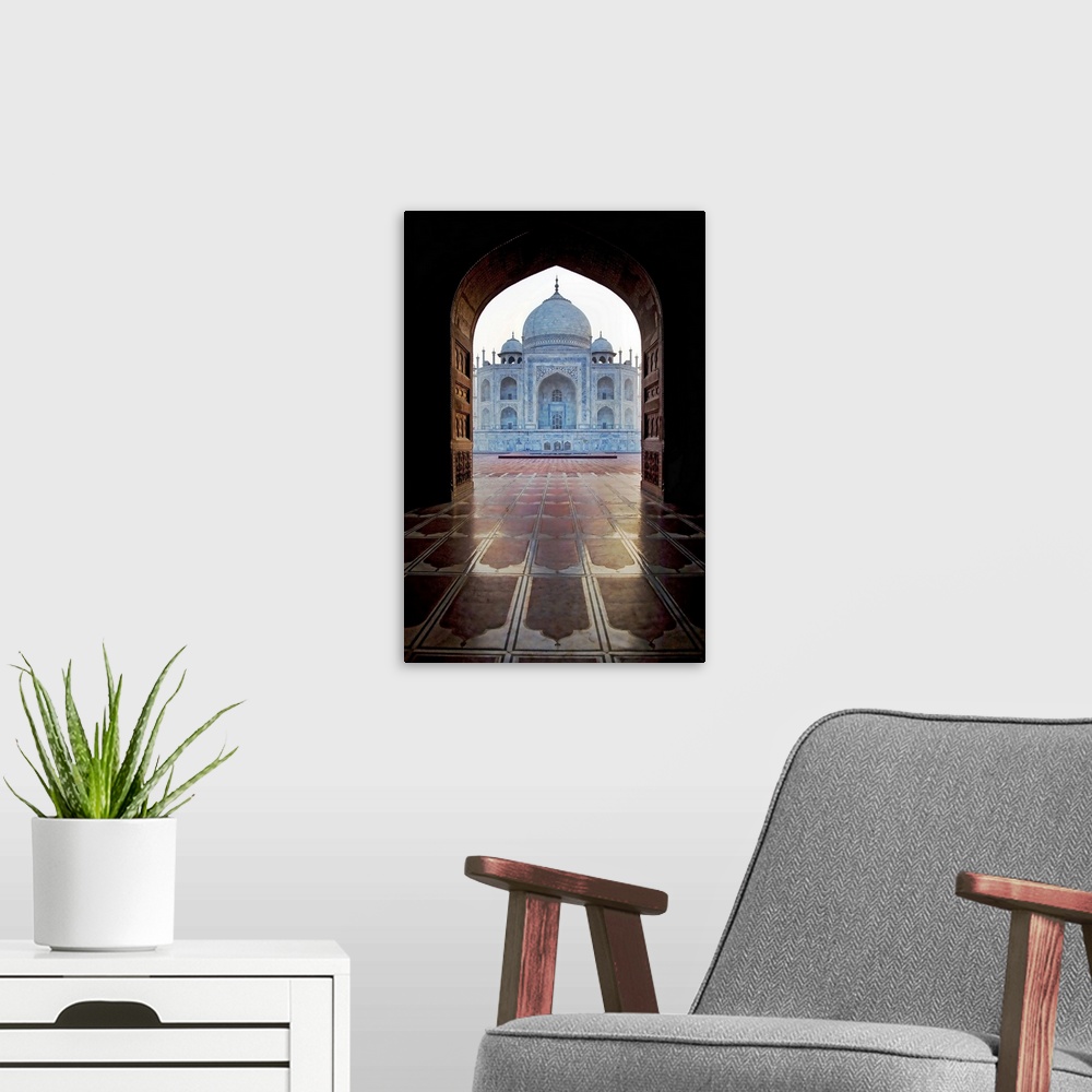A modern room featuring Photograph taken of the Taj Mahal through an archway.