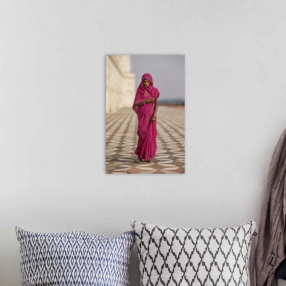 A bohemian room featuring Indian woman in red dress walking by the Taj Mahal, Agra, India