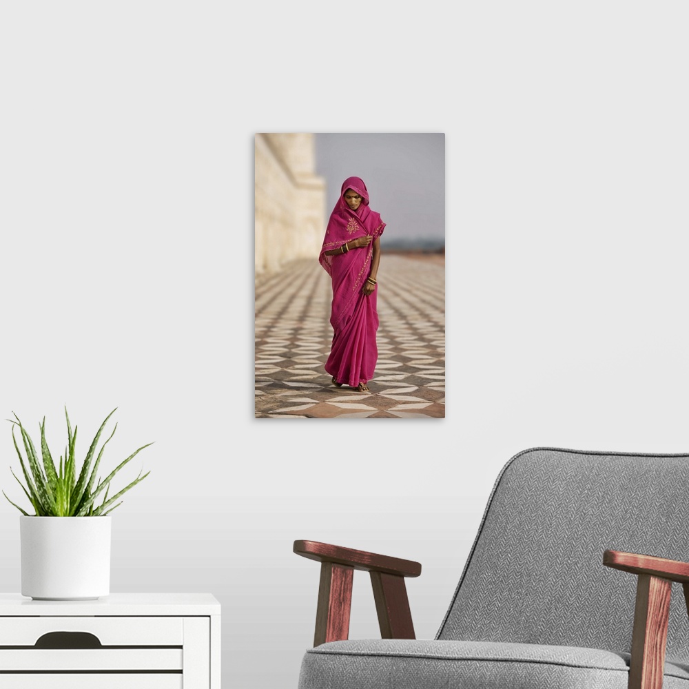 A modern room featuring Indian woman in red dress walking by the Taj Mahal, Agra, India