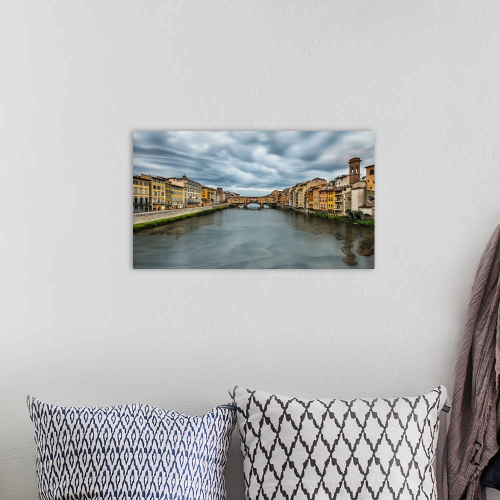A bohemian room featuring The Pontevecchio Bridge in Florence at sunset.