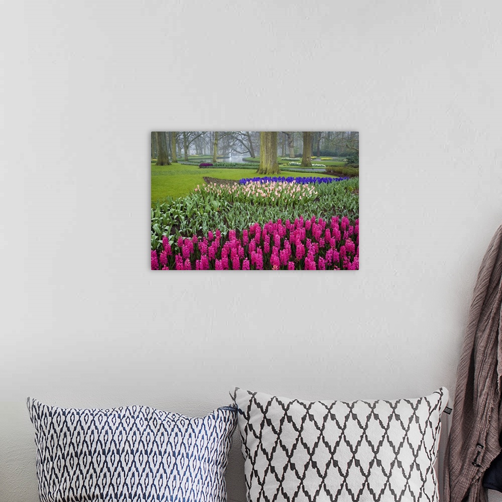 A bohemian room featuring This is a landscape photograph of a garden full of carefully cultivated flowers in meticulously o...