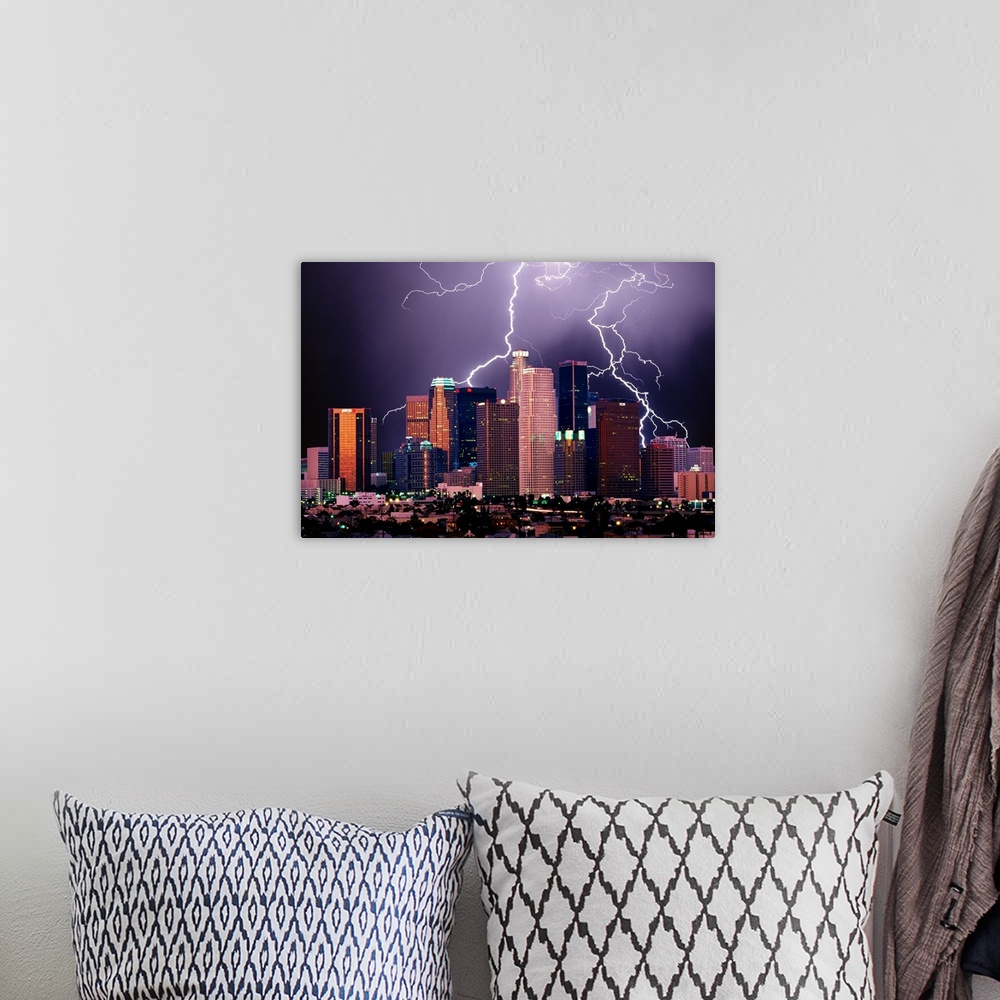 A bohemian room featuring Photograph of lit up skyline at night with storm clouds overhead.