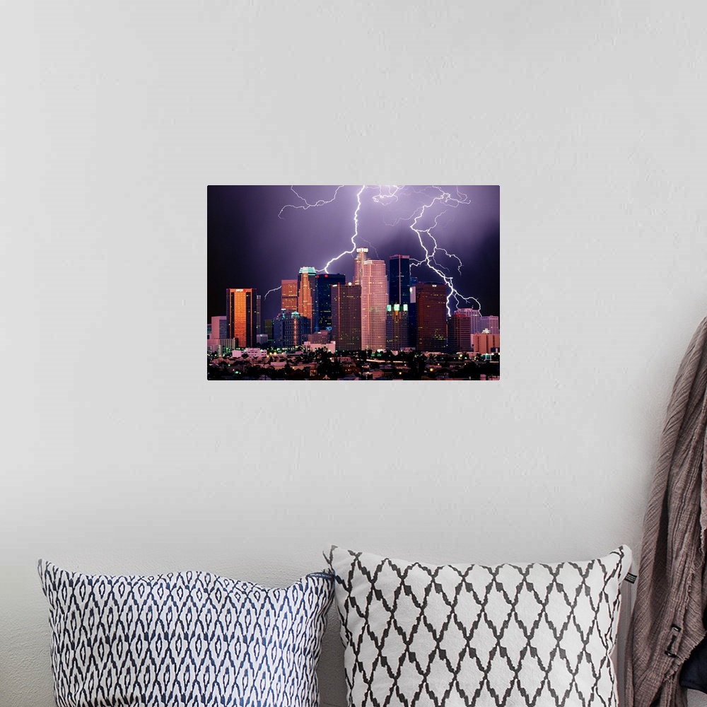A bohemian room featuring Photograph of lit up skyline at night with storm clouds overhead.