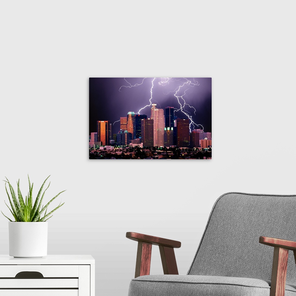 A modern room featuring Photograph of lit up skyline at night with storm clouds overhead.