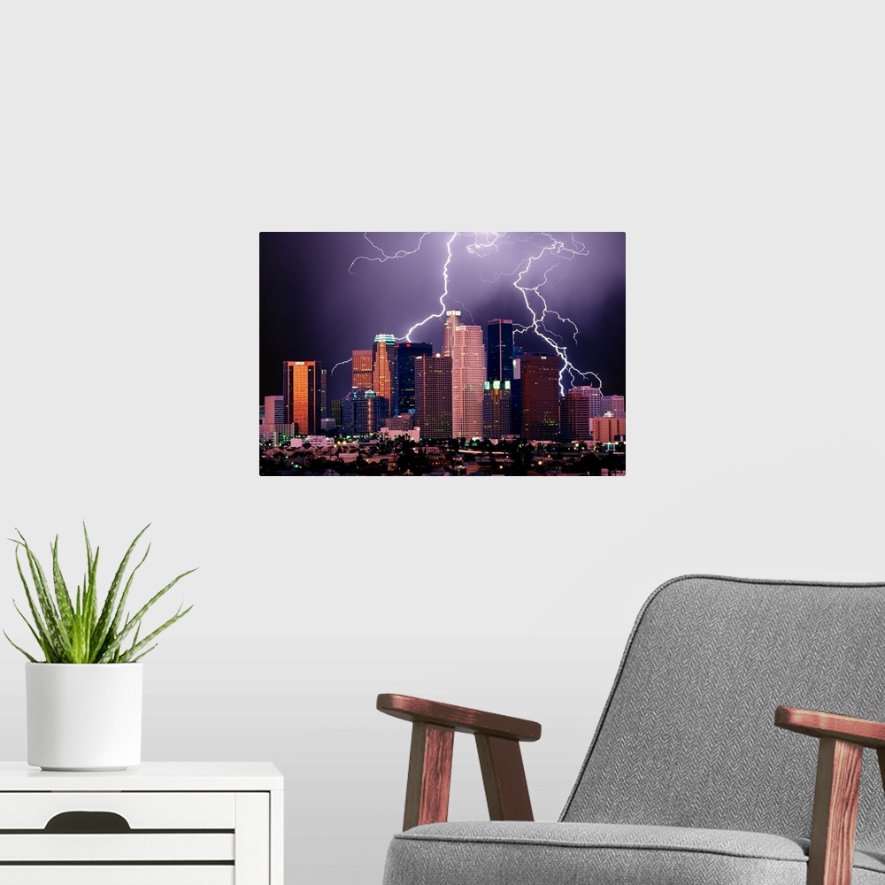 A modern room featuring Photograph of lit up skyline at night with storm clouds overhead.