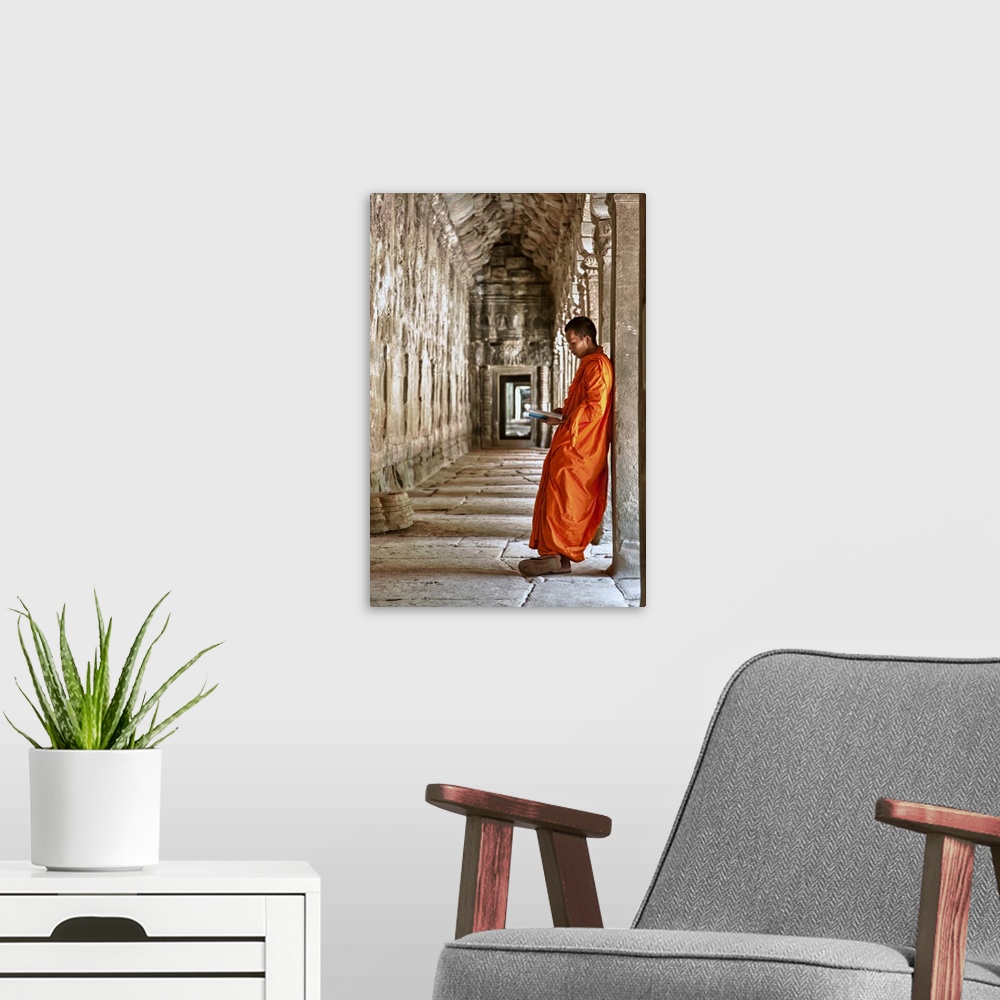 A modern room featuring Monk reading in Angkor Wat, Cambodia