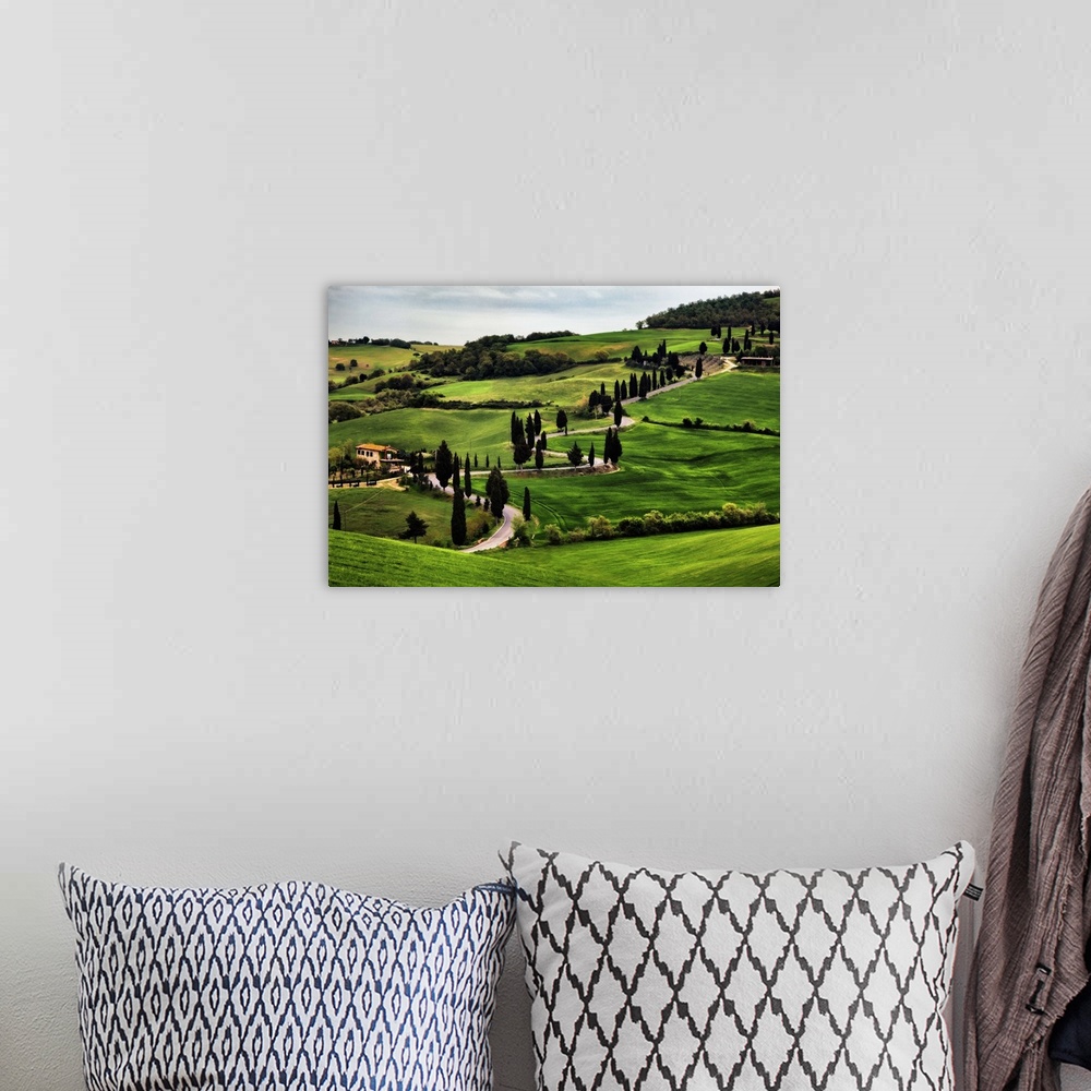 A bohemian room featuring Big canvas print of a countryside with a winding road running through it.