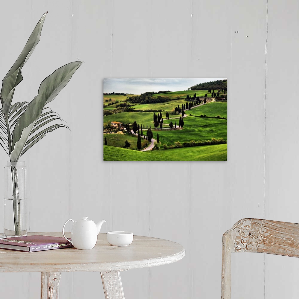 A farmhouse room featuring Big canvas print of a countryside with a winding road running through it.