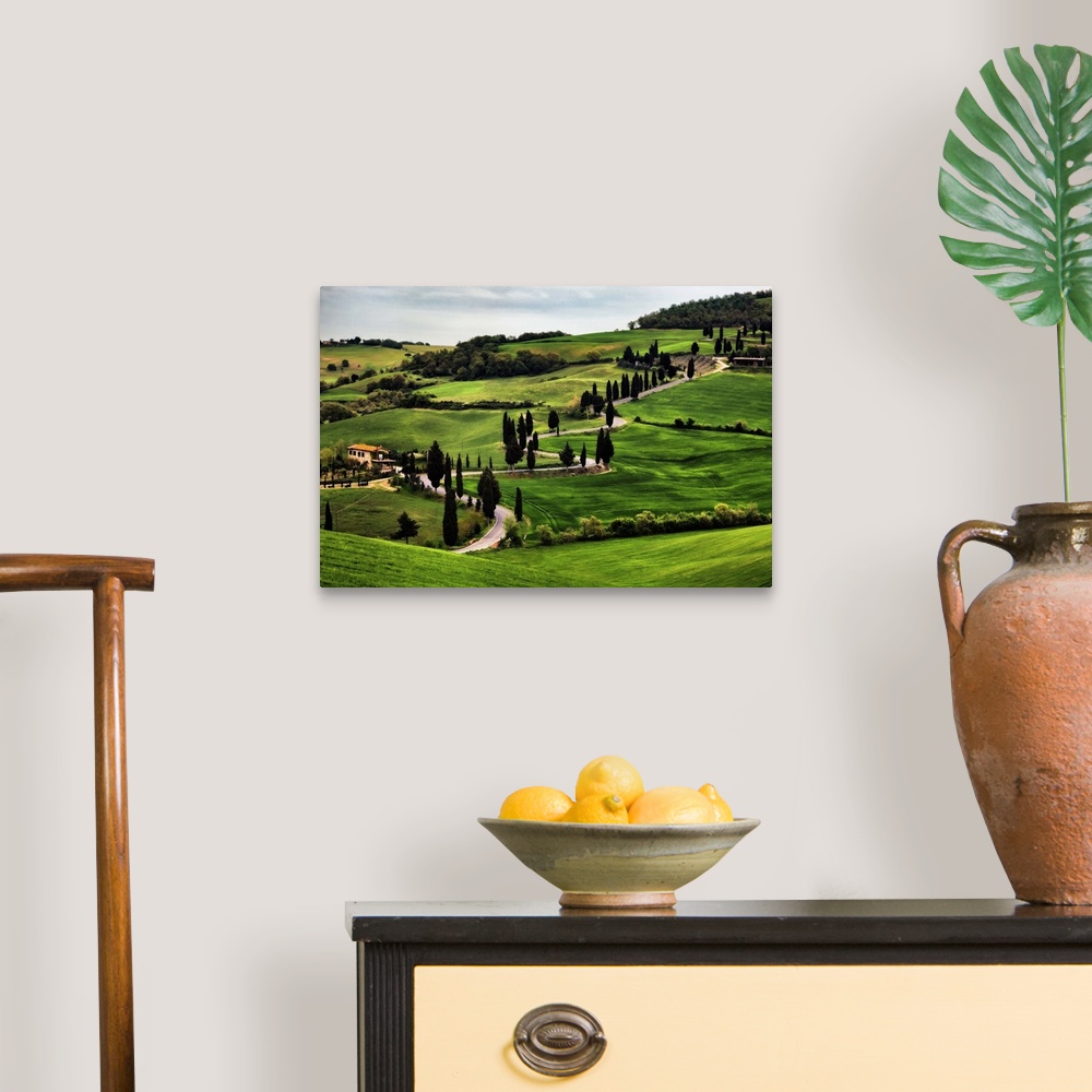 A traditional room featuring Big canvas print of a countryside with a winding road running through it.