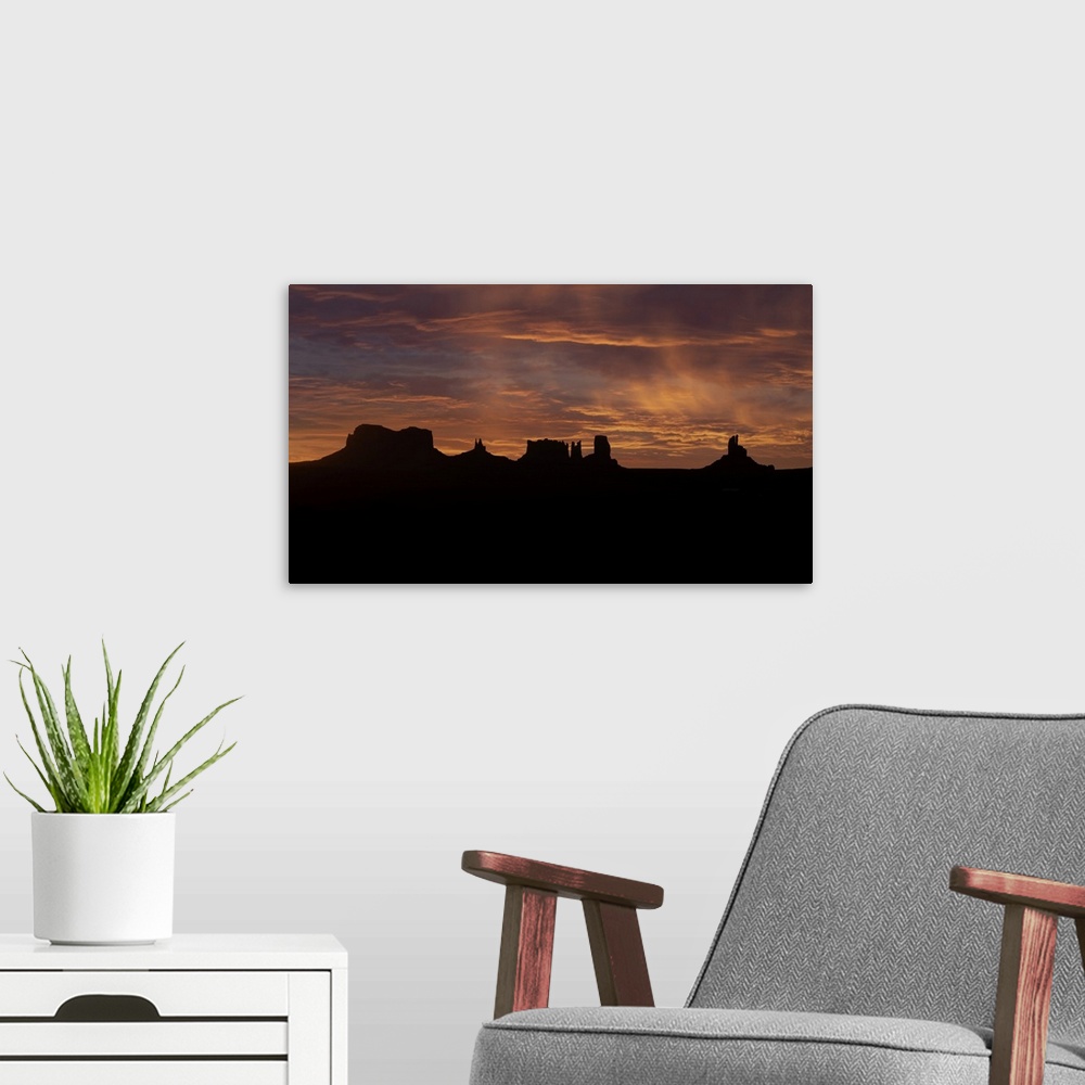 A modern room featuring Monument Valley at sunrise