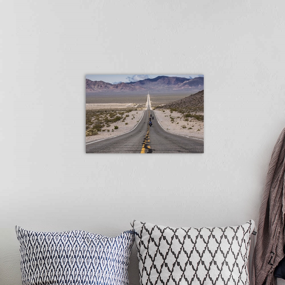 A bohemian room featuring Motorcycles riding long road into Death Valley National Park
