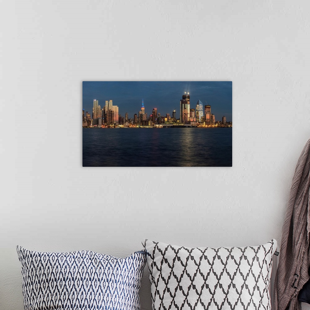 A bohemian room featuring New York City skyline at sunset
