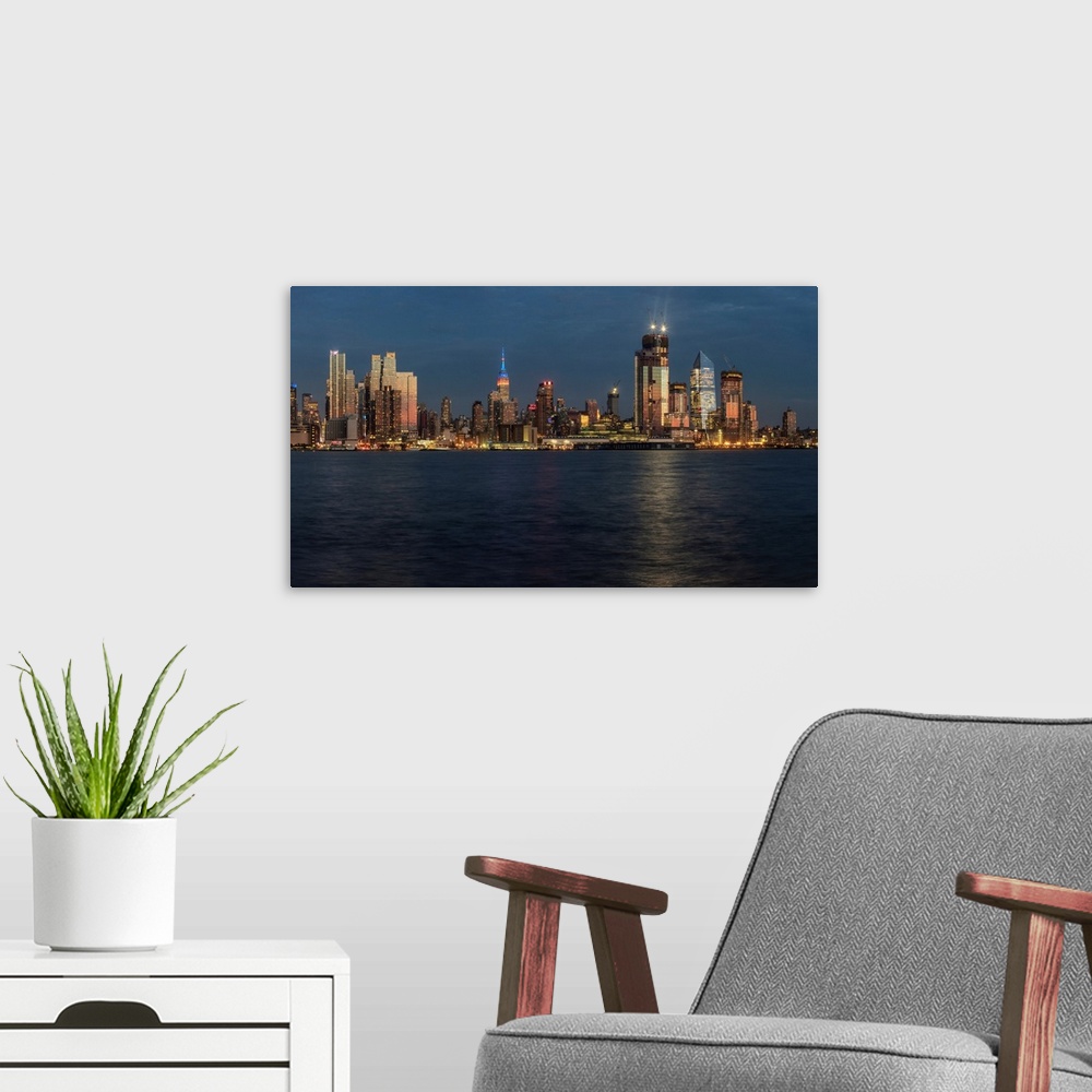 A modern room featuring New York City skyline at sunset