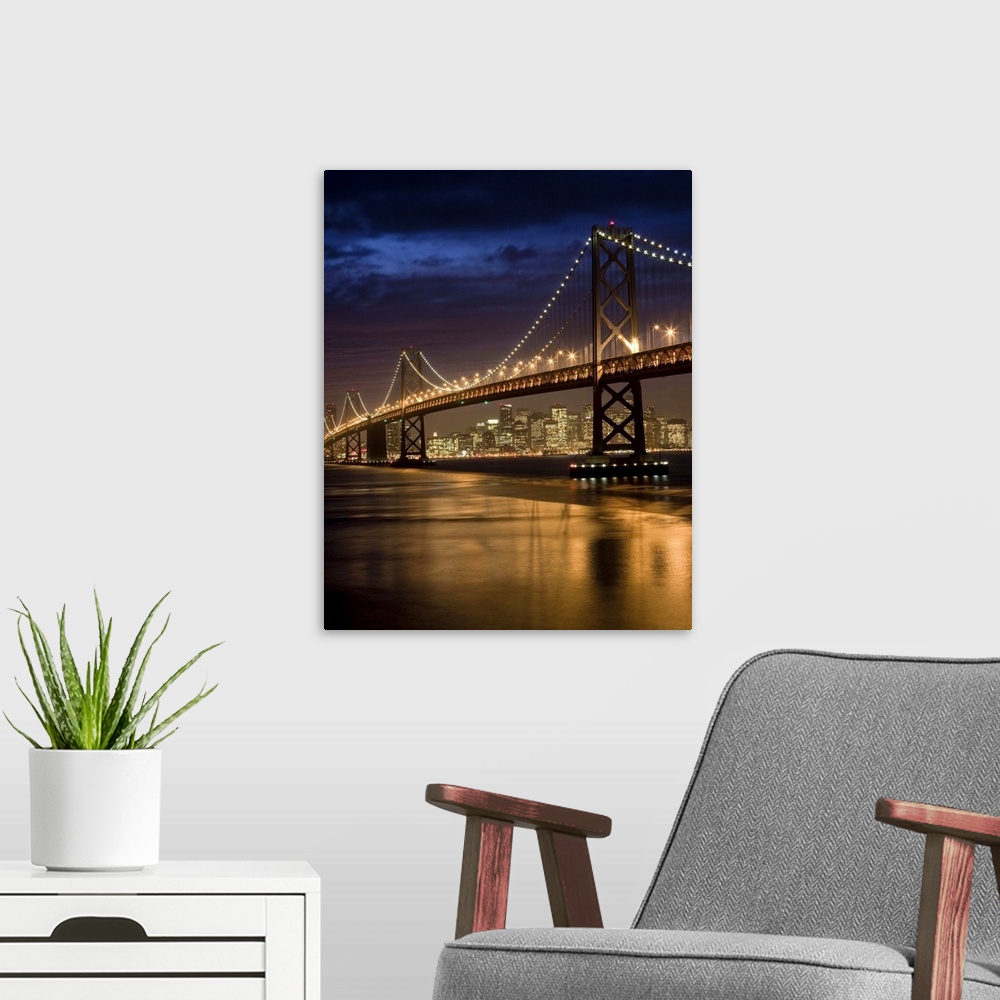 A modern room featuring Oakland Bay Bridge and San Francisco skyline at night