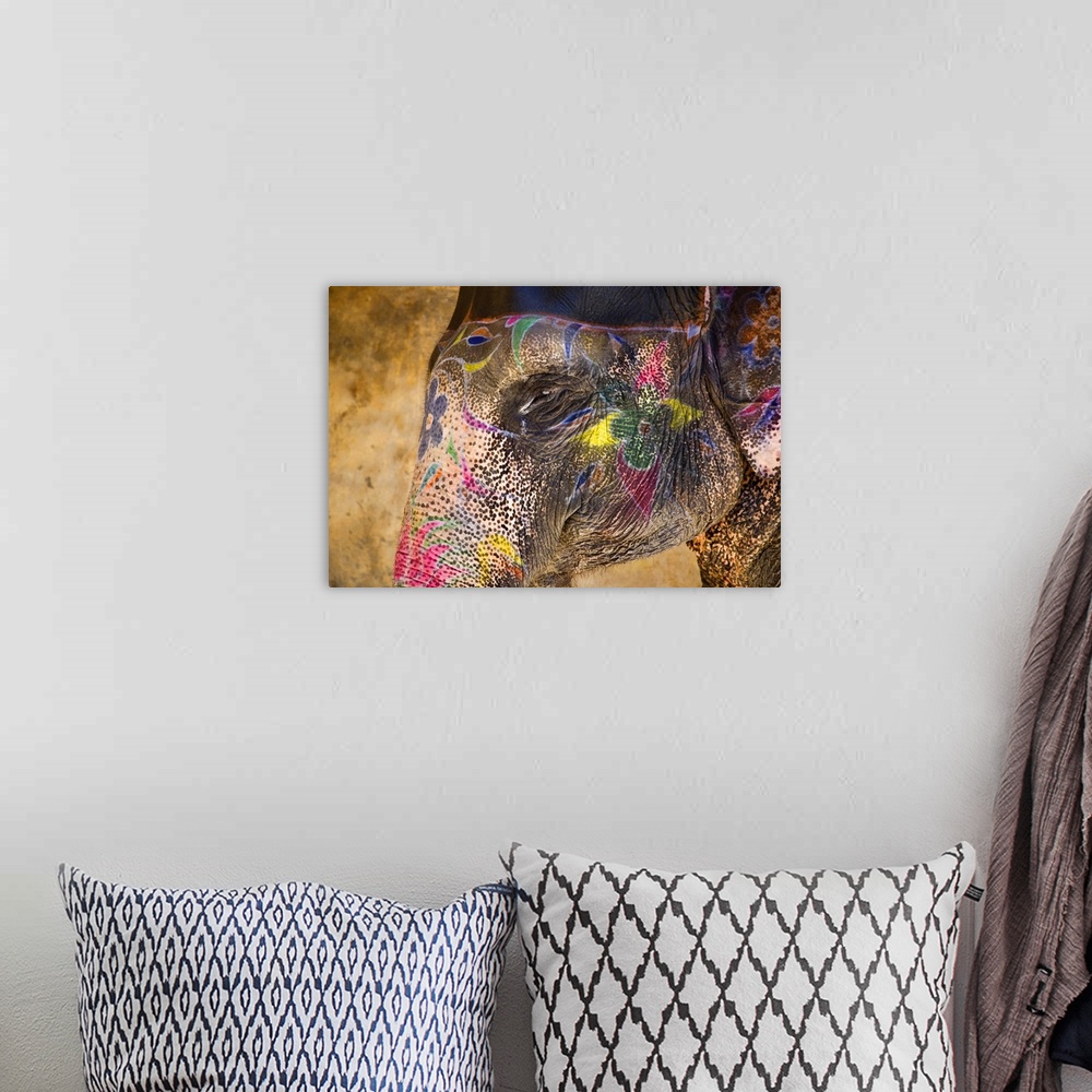 A bohemian room featuring This photograph of an elephant in India is painted beautifully with vibrant colors and flowers.