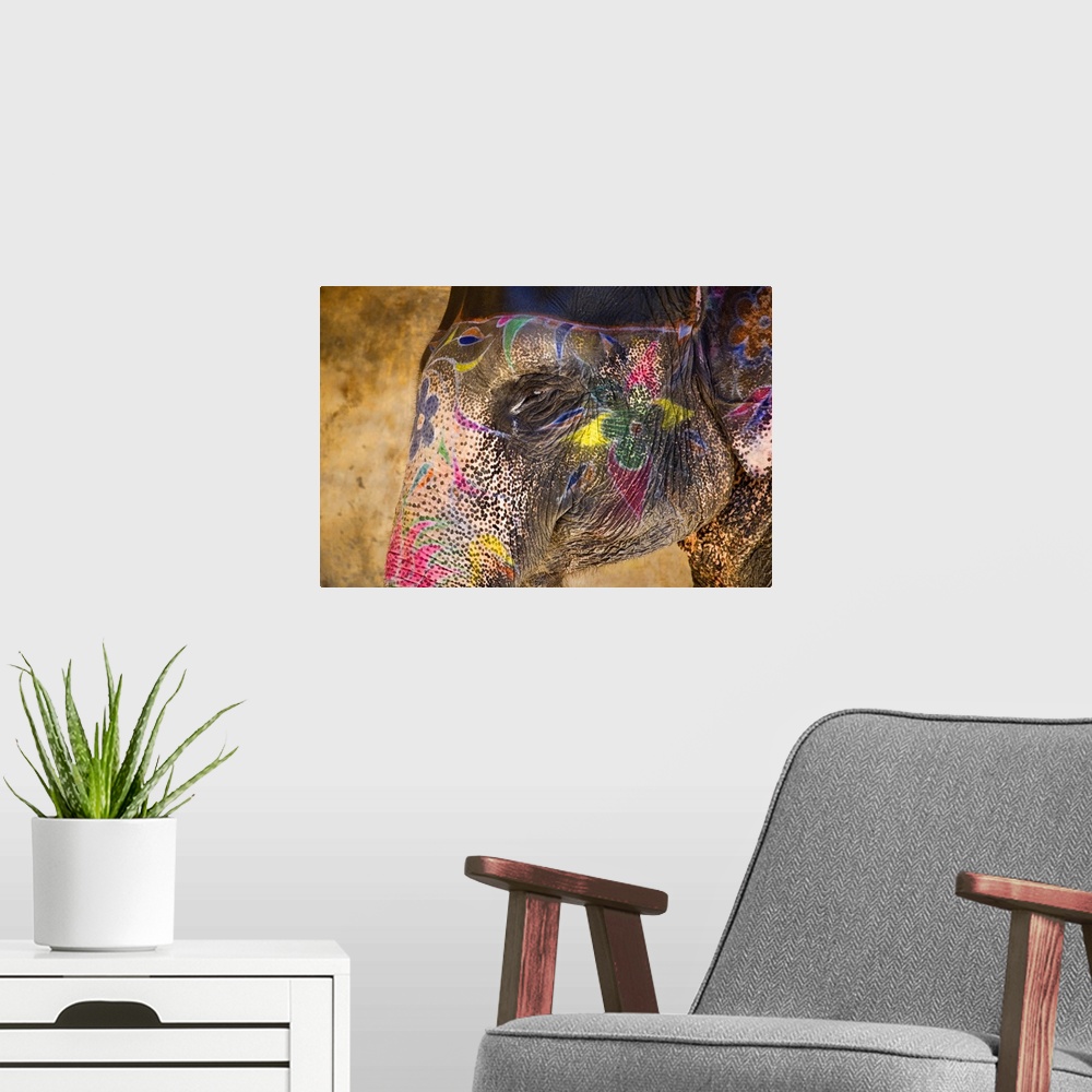 A modern room featuring This photograph of an elephant in India is painted beautifully with vibrant colors and flowers.