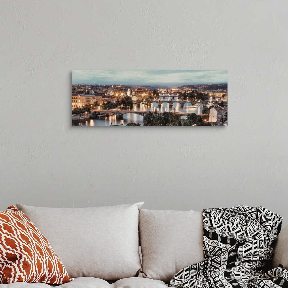 A bohemian room featuring Panorama of Vltava River and bridges in Prague at sunset.