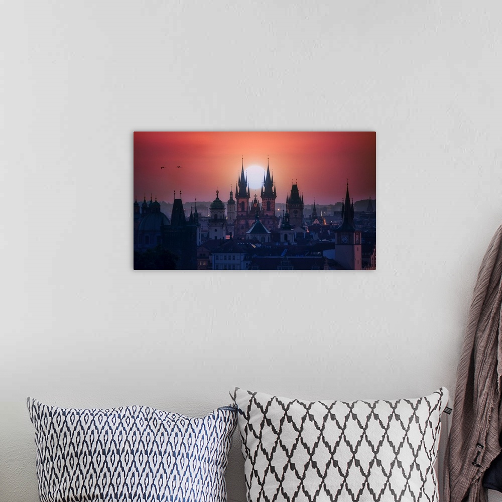 A bohemian room featuring The towers of beautiful Prague at sunrise.