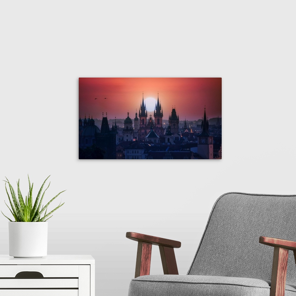 A modern room featuring The towers of beautiful Prague at sunrise.