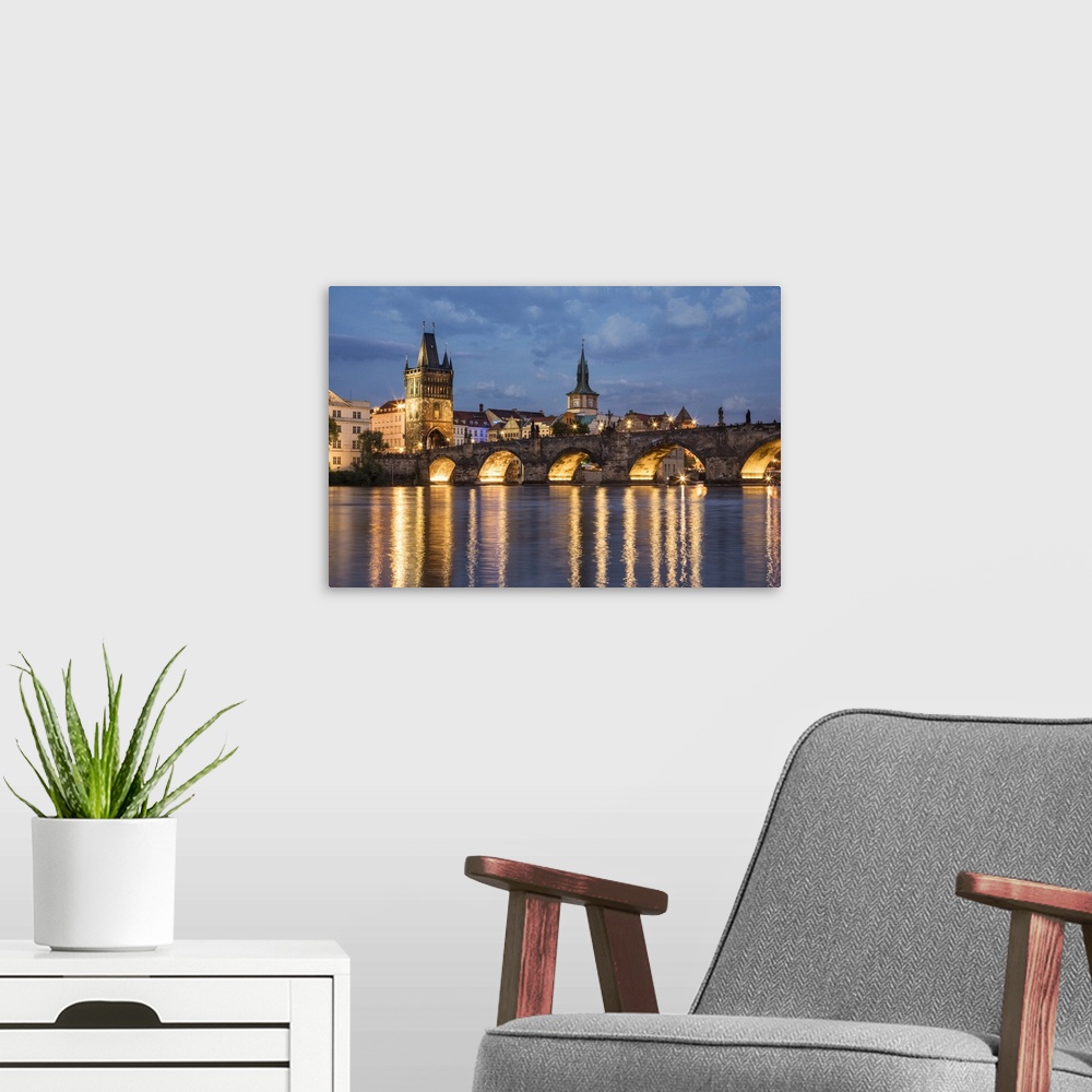 A modern room featuring The stunning Charles Bridge and Prague at sunset.