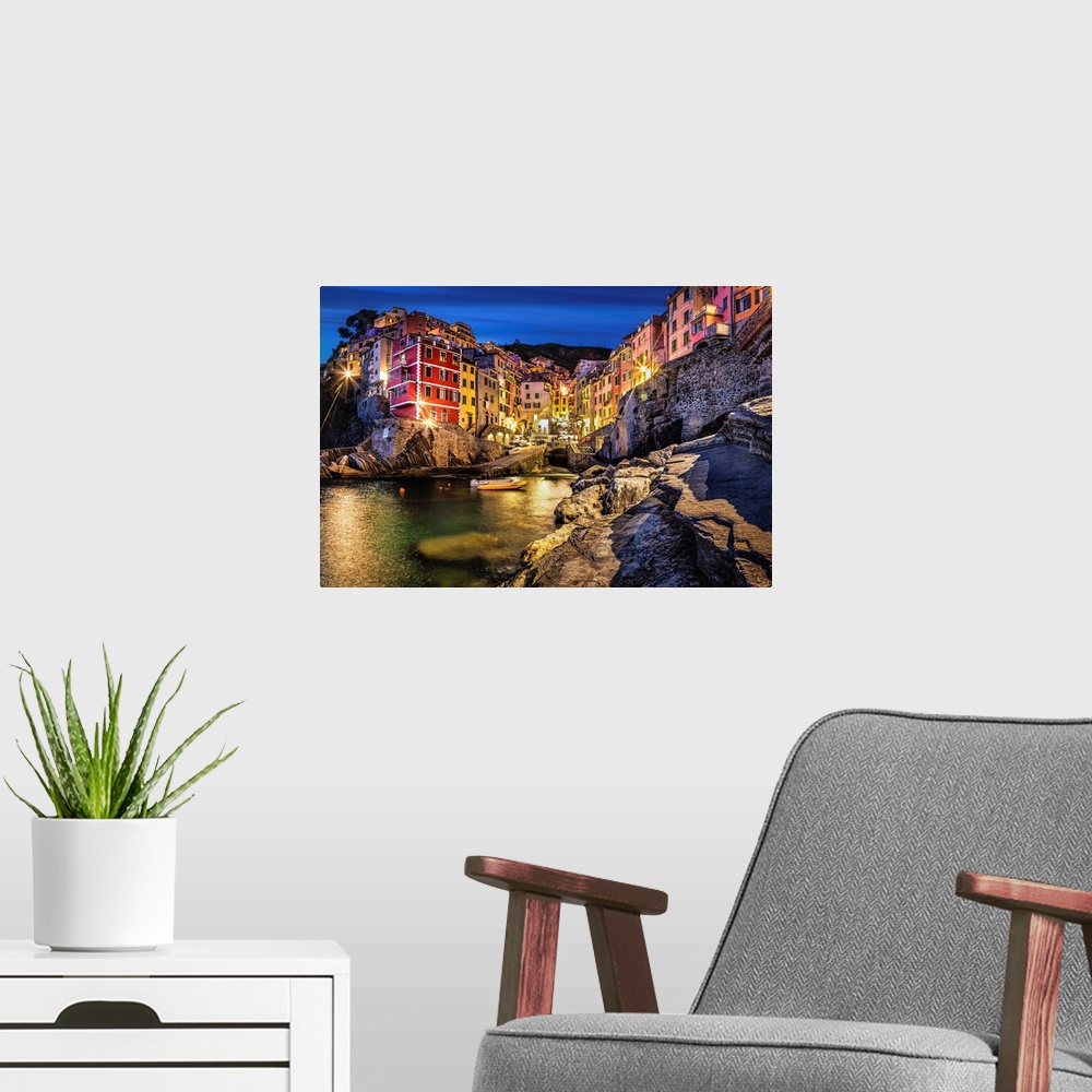 A modern room featuring Riomaggiore in the Cinque Terre at sunset