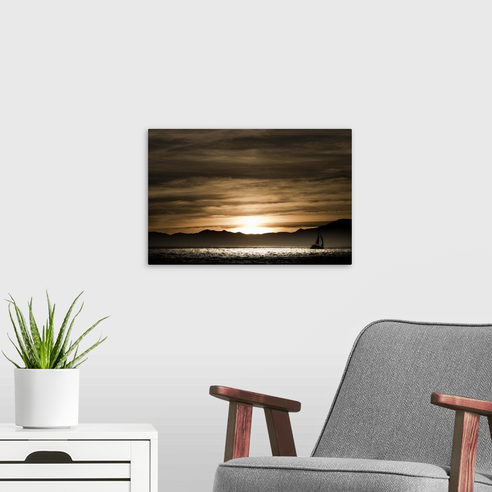 A modern room featuring Sailboat in the ocean at sunset