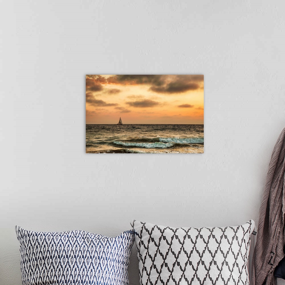 A bohemian room featuring Sailboat off the coast of California at sunset.