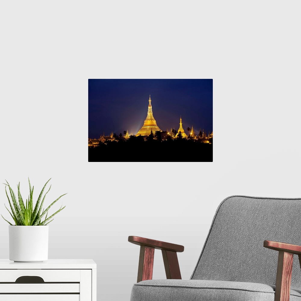 A modern room featuring This landscape photograph shows a religious site illuminated in the night riding above the silhou...