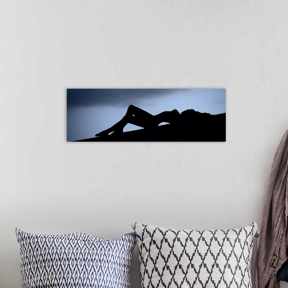 A bohemian room featuring Silhouette of a nude woman outdoors at dusk