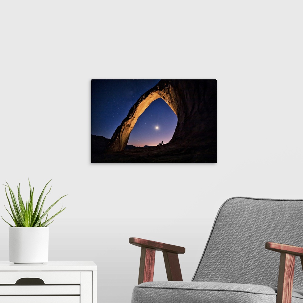 A modern room featuring Silhouette of a woman under Corona Arch in Moab, Utah