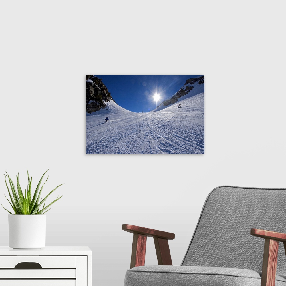 A modern room featuring This large piece is a photograph taken from the bottom of a mountain and looking up toward the to...
