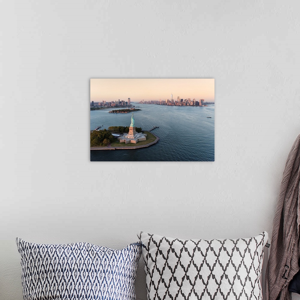 A bohemian room featuring Stature of Liberty and Manhattan from above at sunset