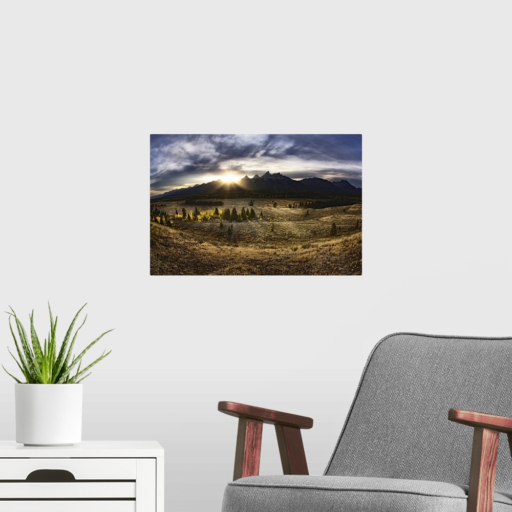 A modern room featuring Giant, landscape photograph of a vast field in Jackson Hole, Wyoming, the sun rising just above t...